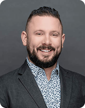 Professional man in a suit smiling, representing Canadian Hospital Specialties Ltd.