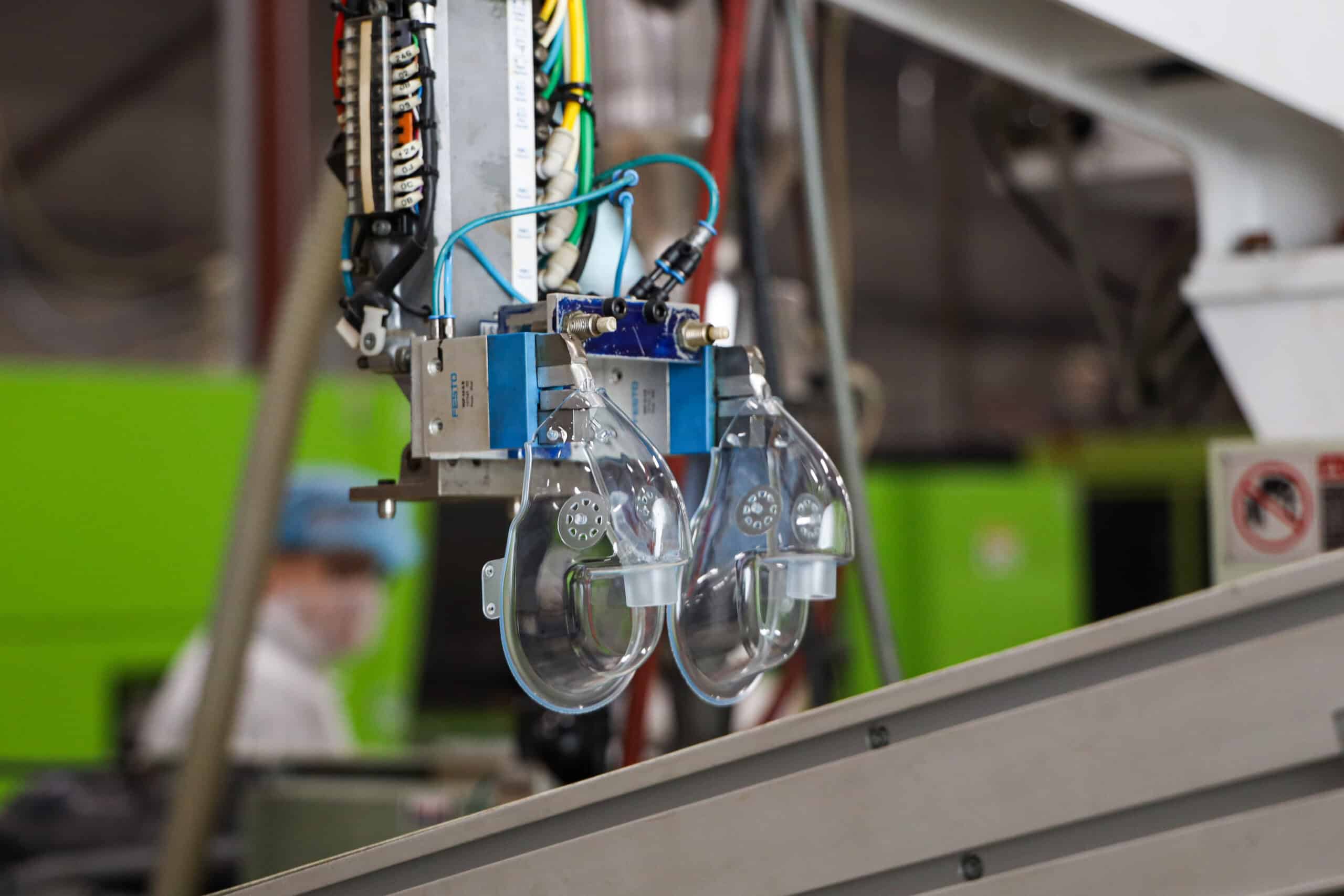 High-tech medical equipment with transparent components and wiring in a clinical setting.