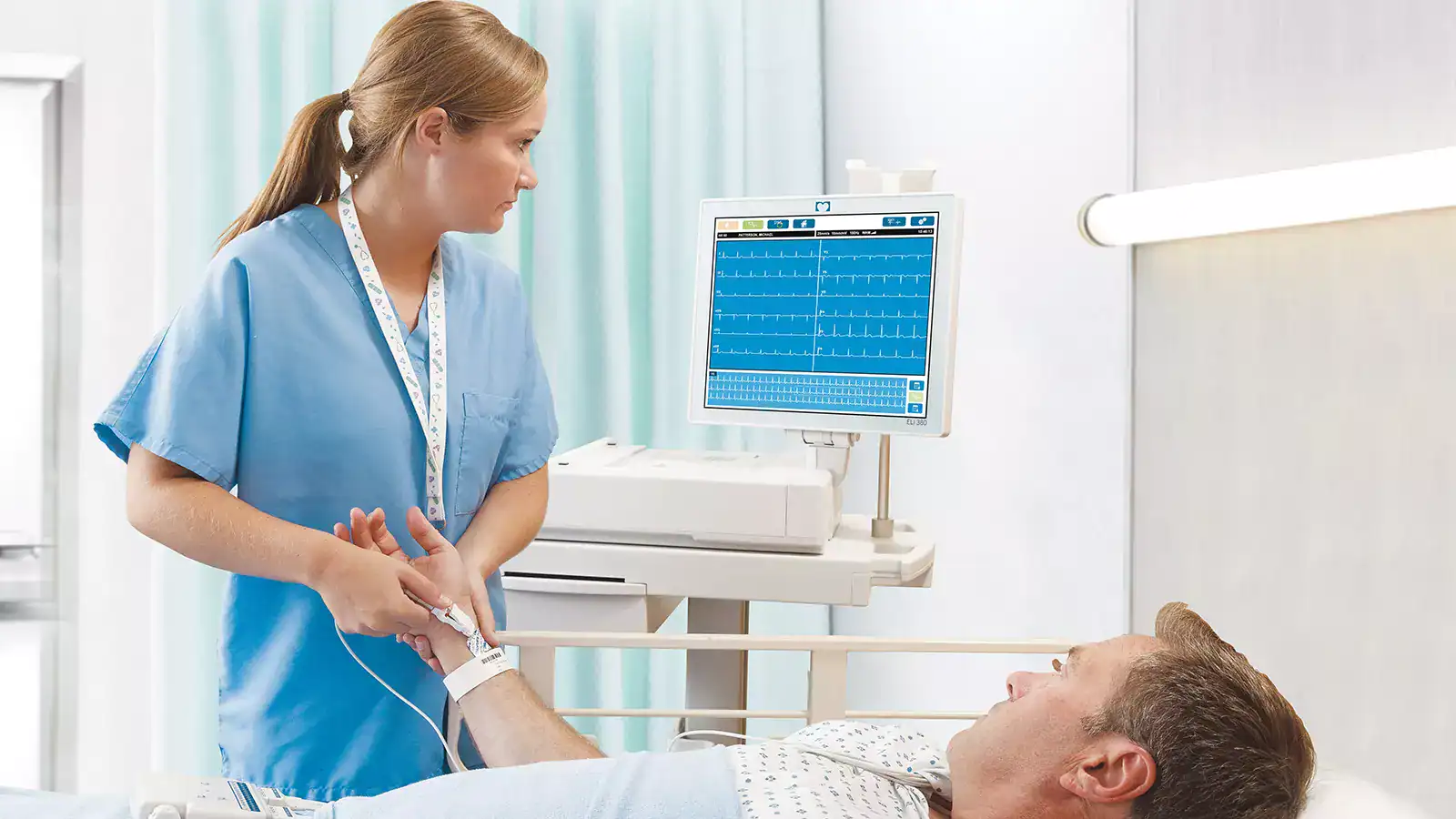 Healthcare professional monitoring patient vital signs.