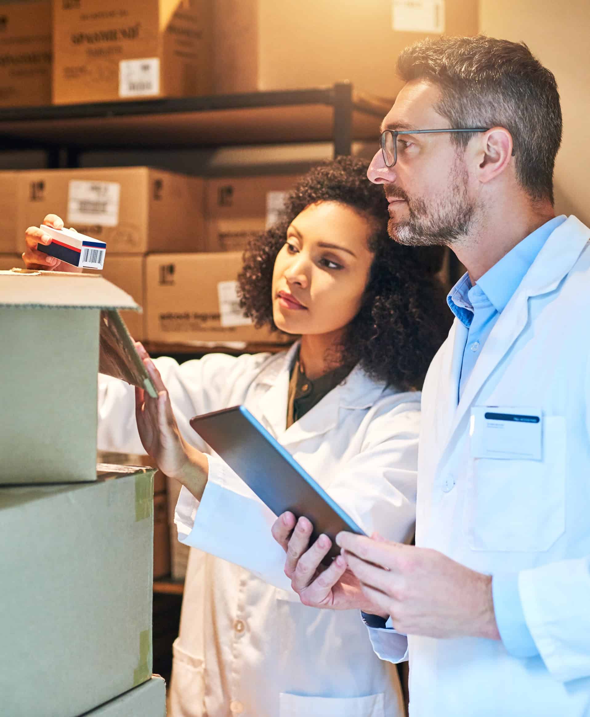 Healthcare professionals inspecting hospital supplies in storage warehouse.