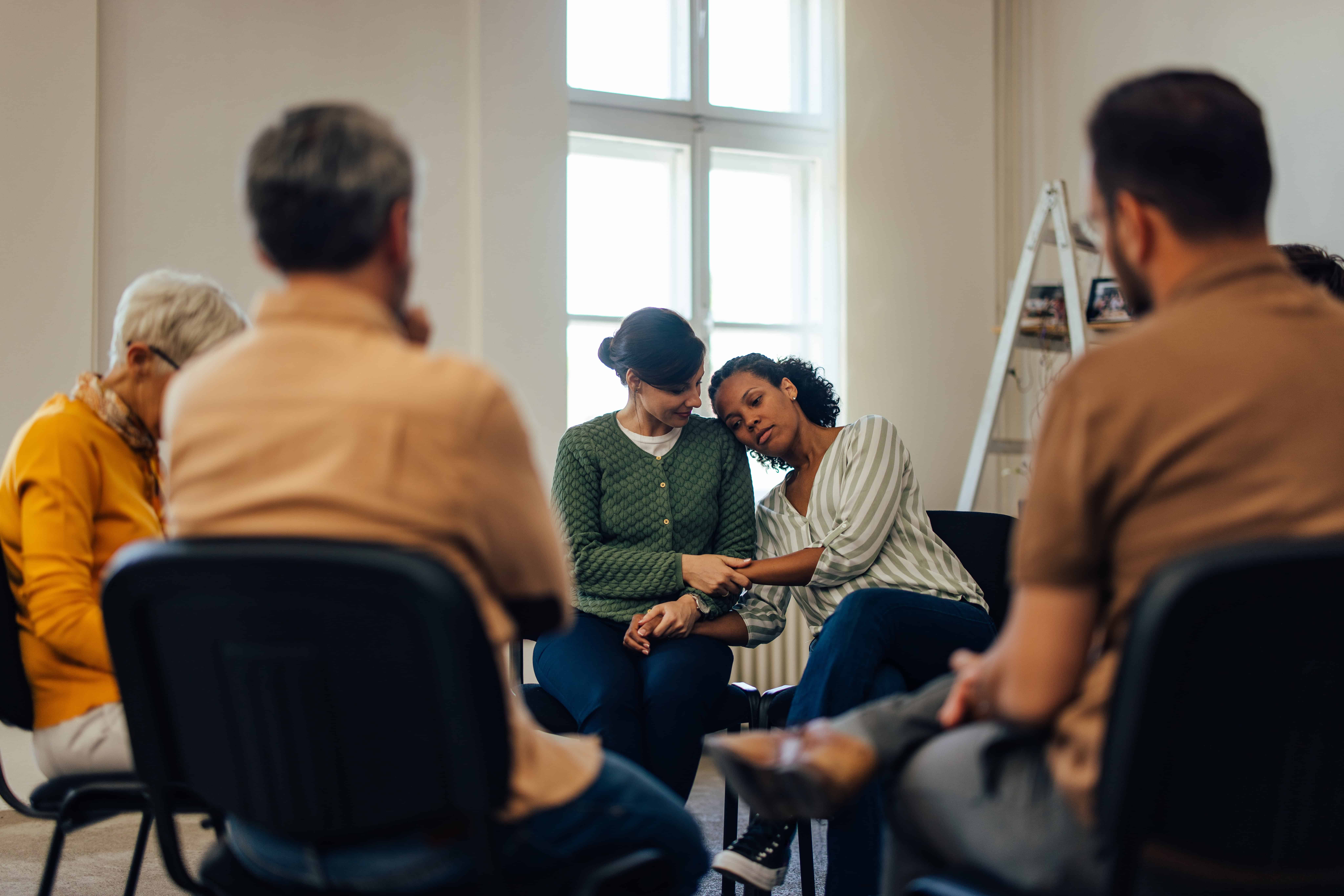 Group therapy session with diverse participants.