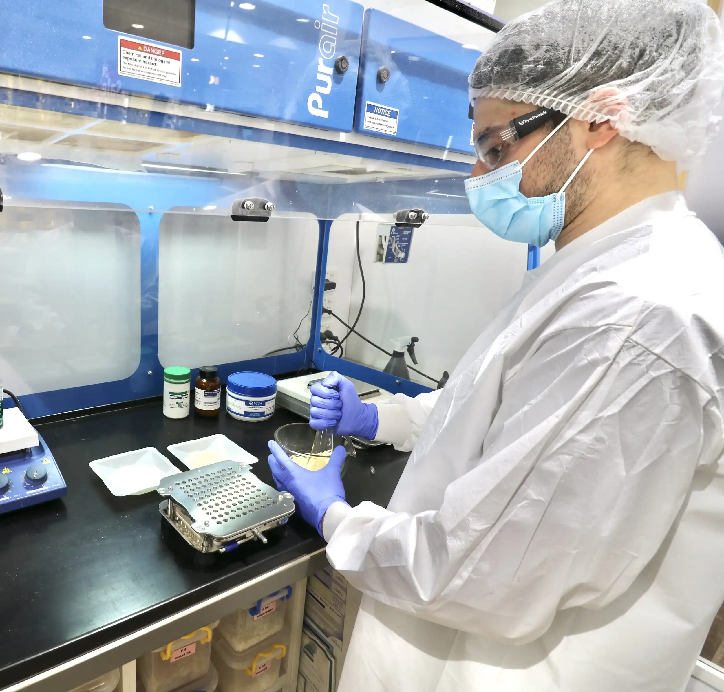 Laboratory scientist working with samples in a clean lab environment.